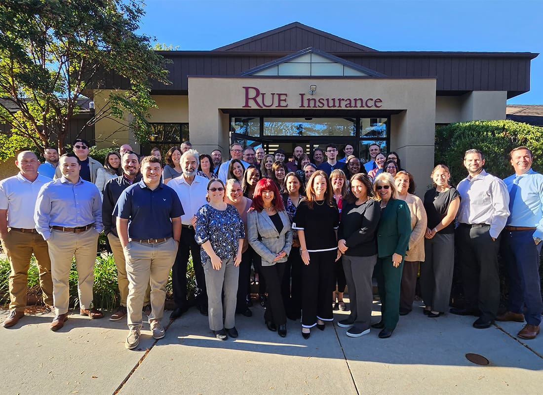 About - Group Photo of Rue Insurance Team Outside Office Building